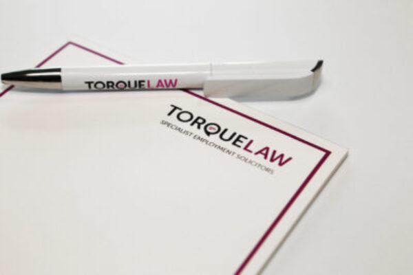 Torque Law headed paper and pen